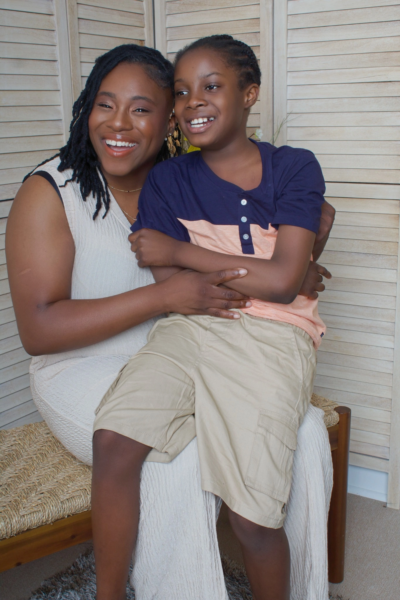 Dr. Crystal Jordan, L.H.D., and her son Zachariah smiling together in yellow outfits.