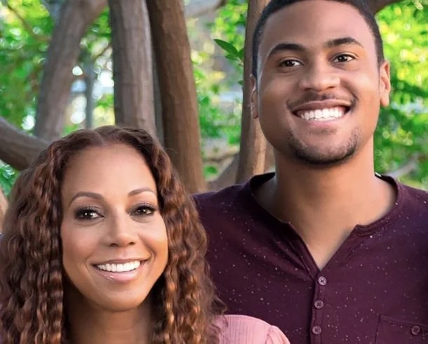 Holly Robinson Peete and her son RJ Peete smiling together outdoors.