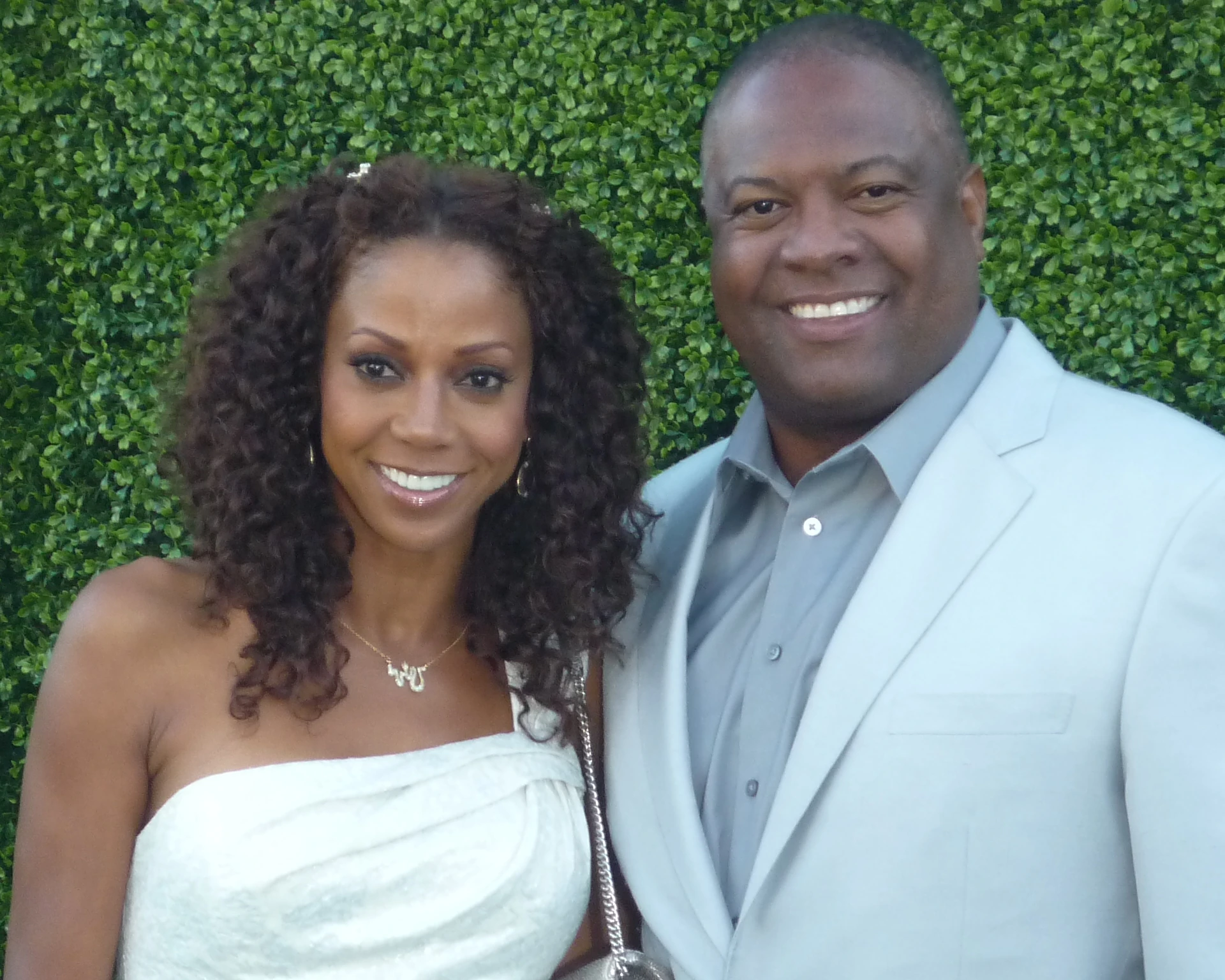 Holly Robinson Peete and Rodney Peete standing together outdoors