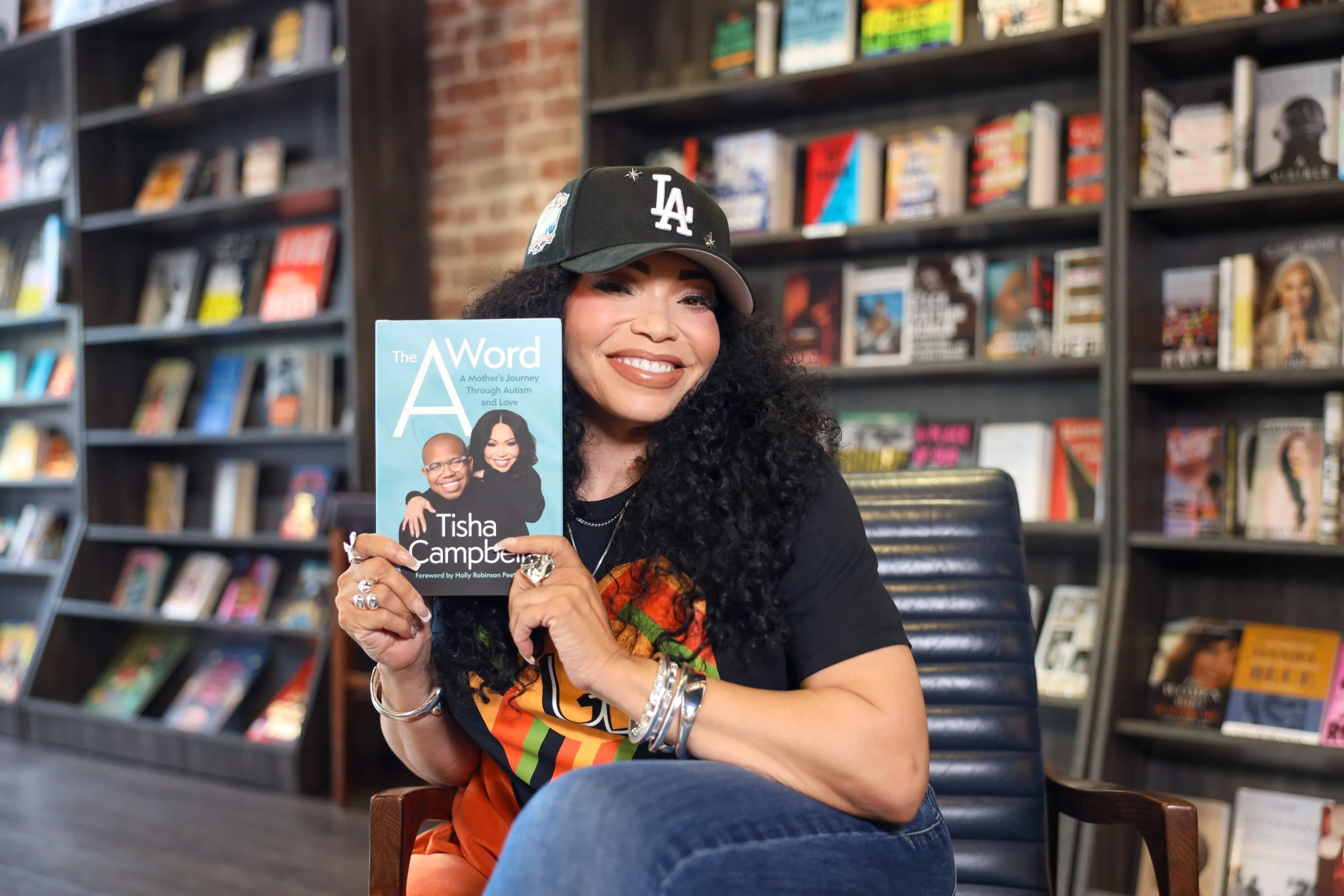 Tisha Campbell holding The A Word.