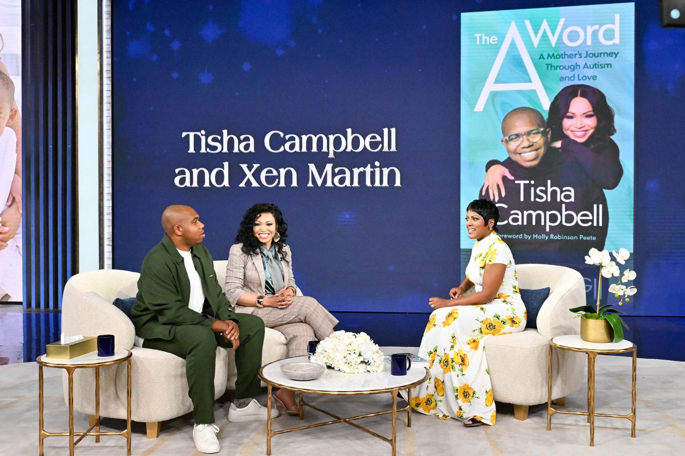 Xen Martin and his mother Tisha Campbell seated with Tamron Hall on the Tamron Hall set.